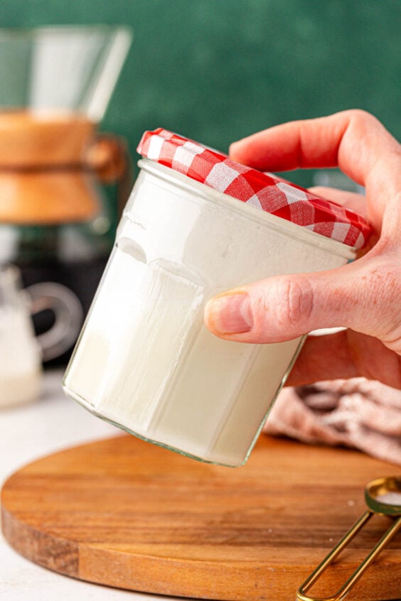 A jar of cream being shaken.