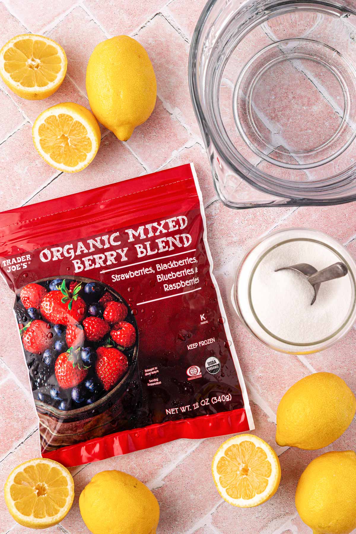 Ingredients to make berry lemonade on a table.