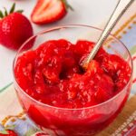 Close up of a bowl of strawberry cake filling.