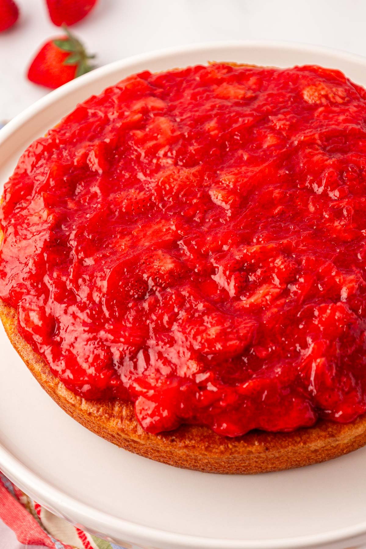 Strawberry filling on top of a round cake.