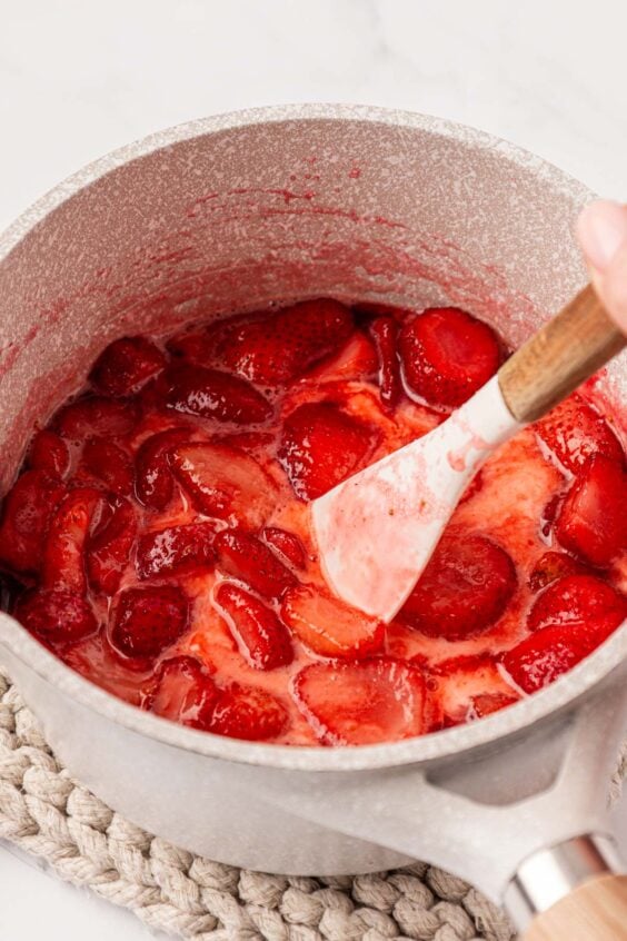 Strawberry filling being made in a pot.