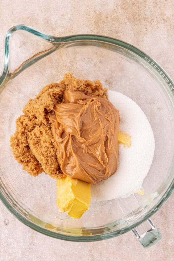 Peanut butter, butter, and sugar in a mixing bowl.
