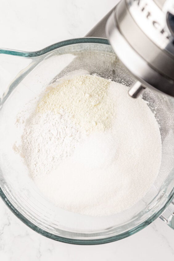 Sugar and flour in a glass mixing bowl.