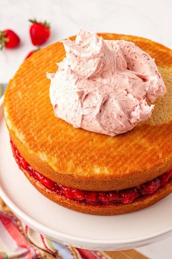 Frosting being added to cake.