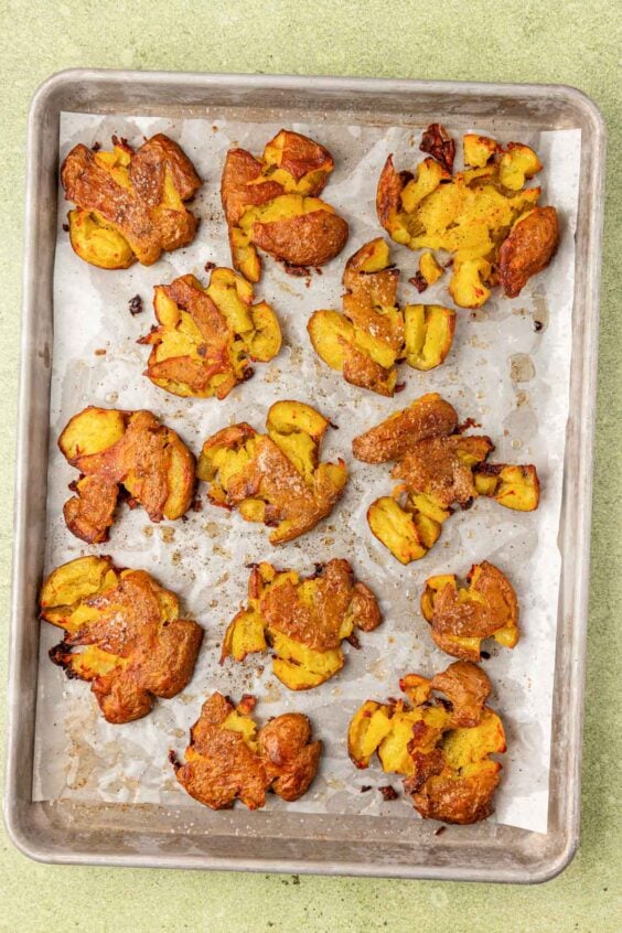 Crispy smashed potatoes on a sheet pan.