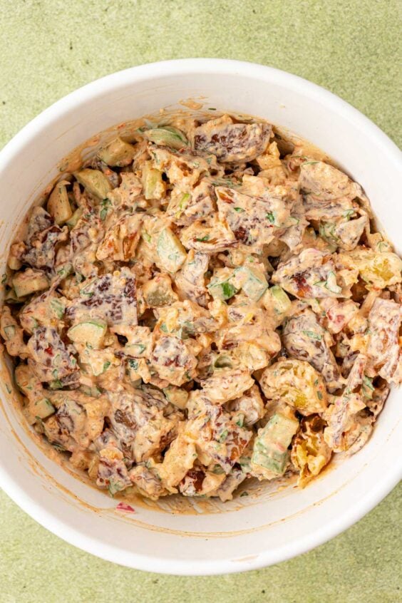 Chili Crisp potato salad coated in dressing in a bowl.