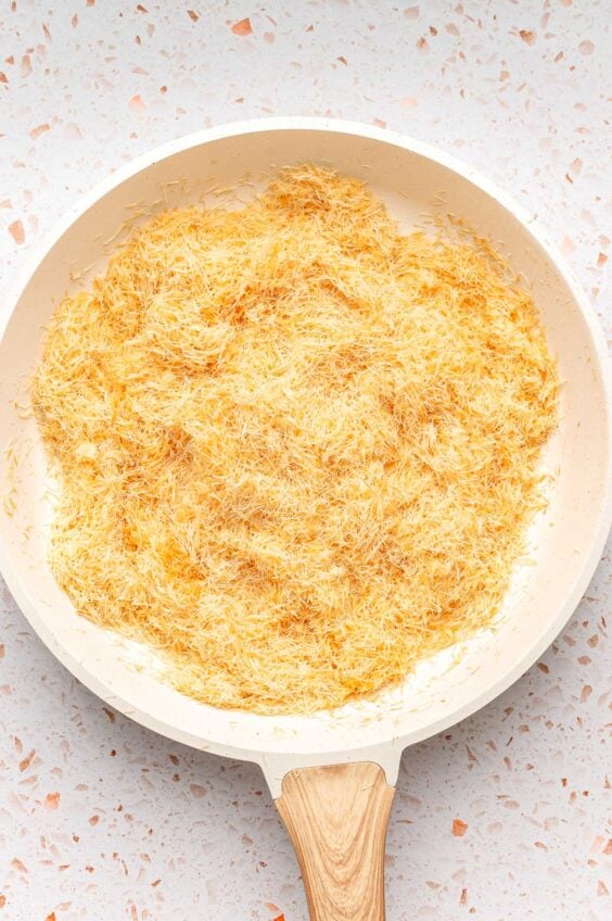Toasted kataifi in a skillet.