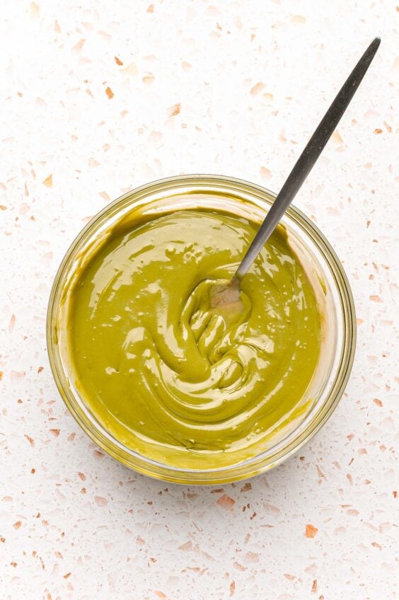 Pistachio cream and tahini mixed together in a bowl.