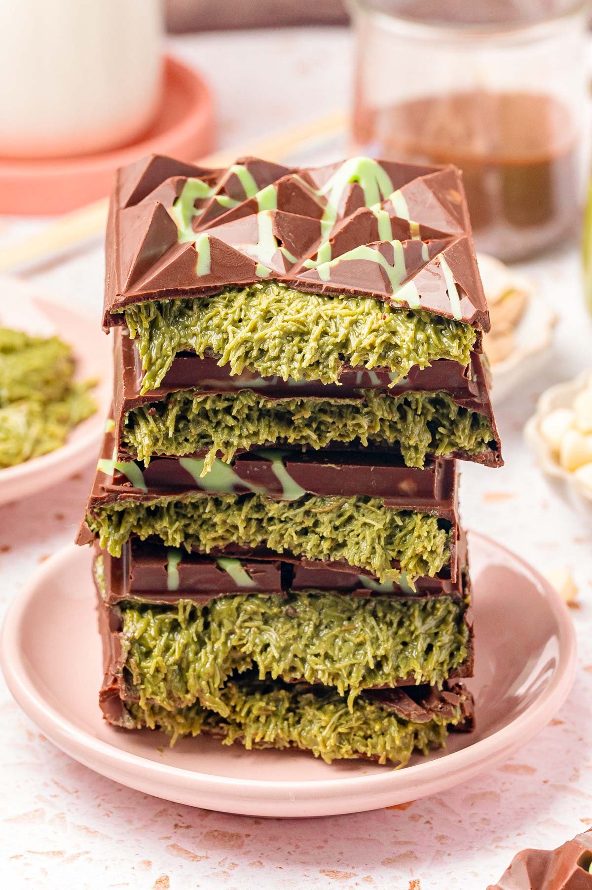 Close up of a stack of Dubai Chocolate Bars that have been broken in half to reveal the filling in the center.