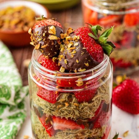 A jar filled with strawberries and Dubai pistachio filling.