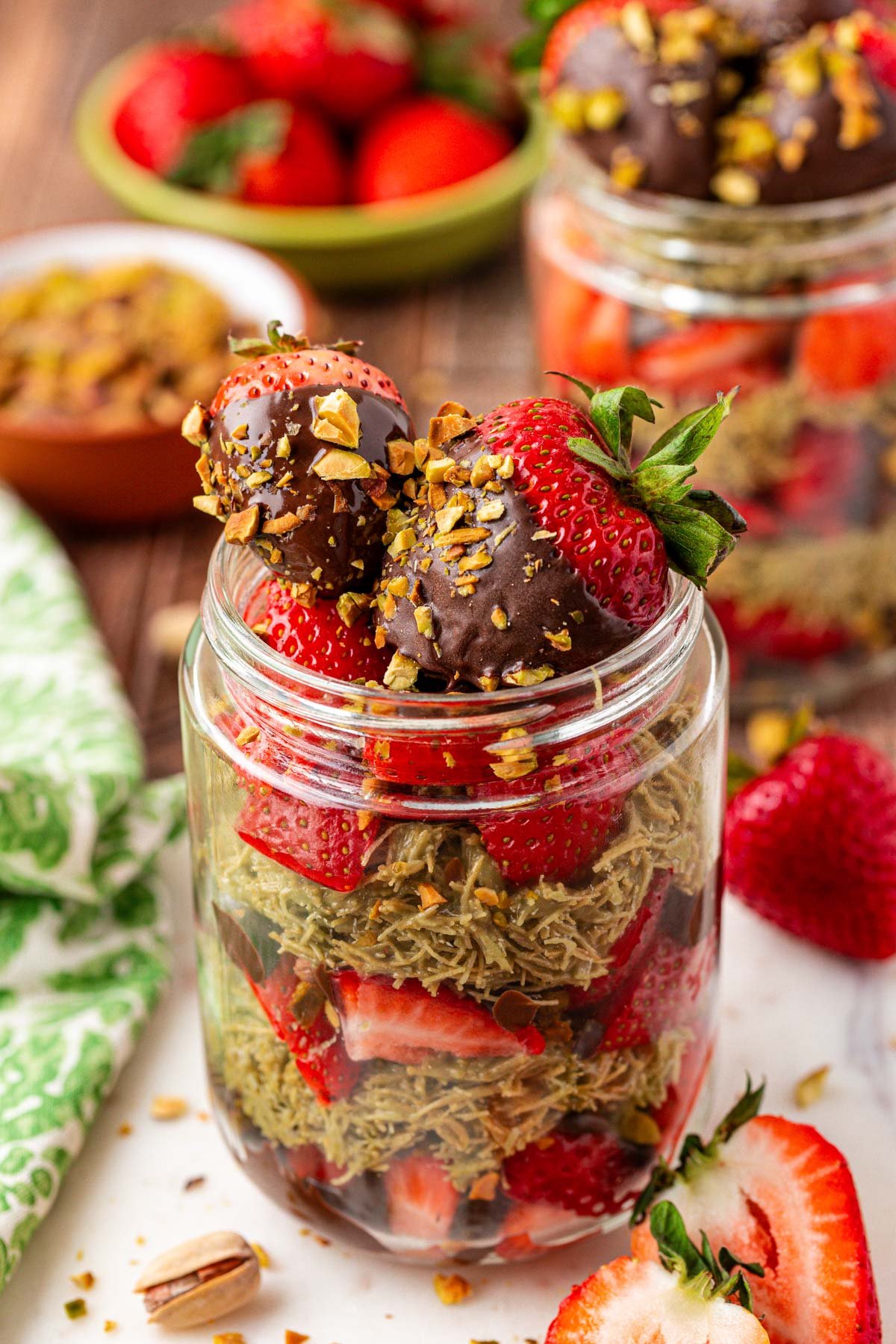 A jar filled with strawberries and Dubai pistachio filling.