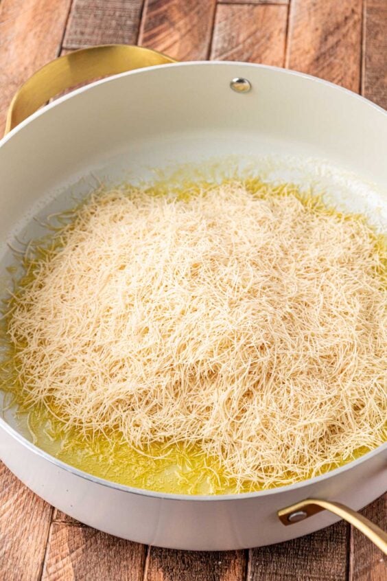 Kataifi in a pan with melted butter.