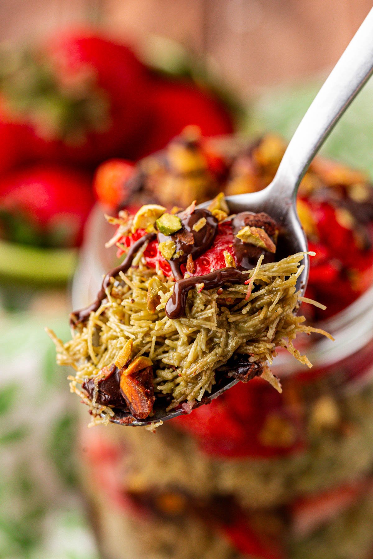 A spoonful of a strawberry Dubai cup.