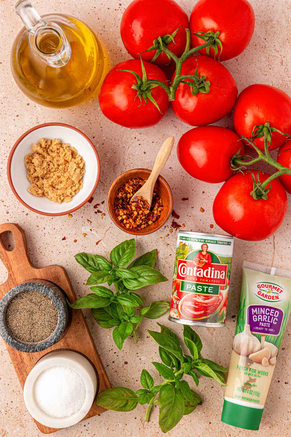Ingredients to make fresh tomato sauce on a table.