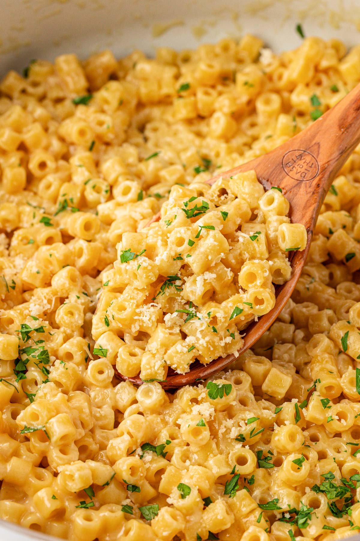 A wooden spoon in a pan of viral ditalini pasta.
