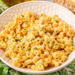 A bowl of creamy ditalini pasta on a green napkin.