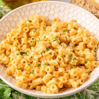 A bowl of creamy ditalini pasta on a green napkin.
