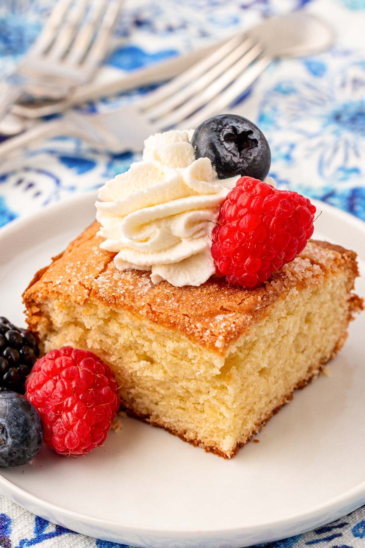 Close up of a square slice of fluffy butter cake.