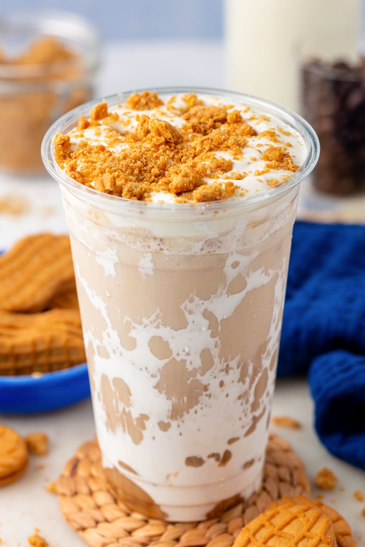 Close up of a plastic cup with a homemade fluffy seagull latte in it.