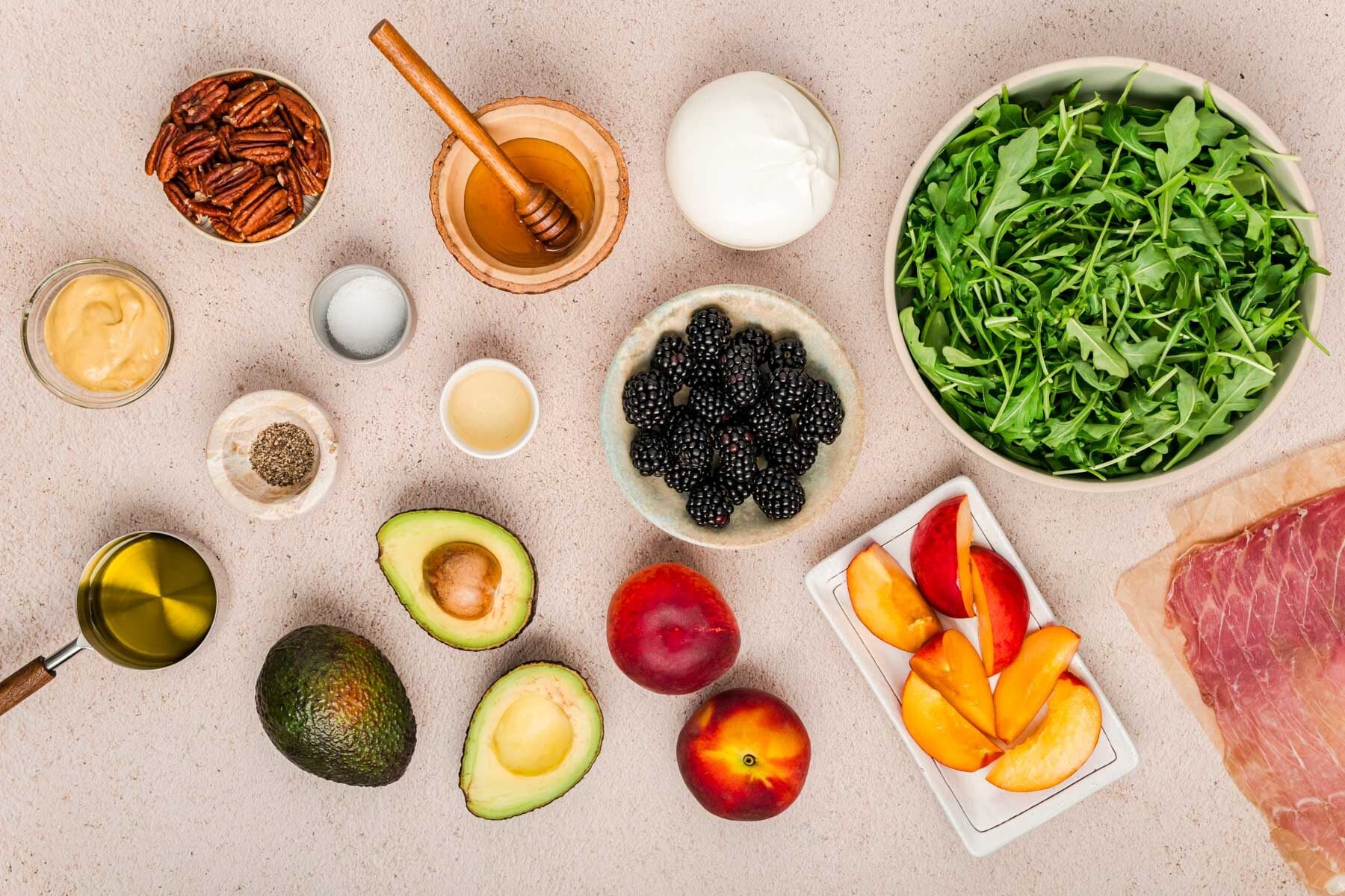 Ingredients to make peach burrata salad on a counter.