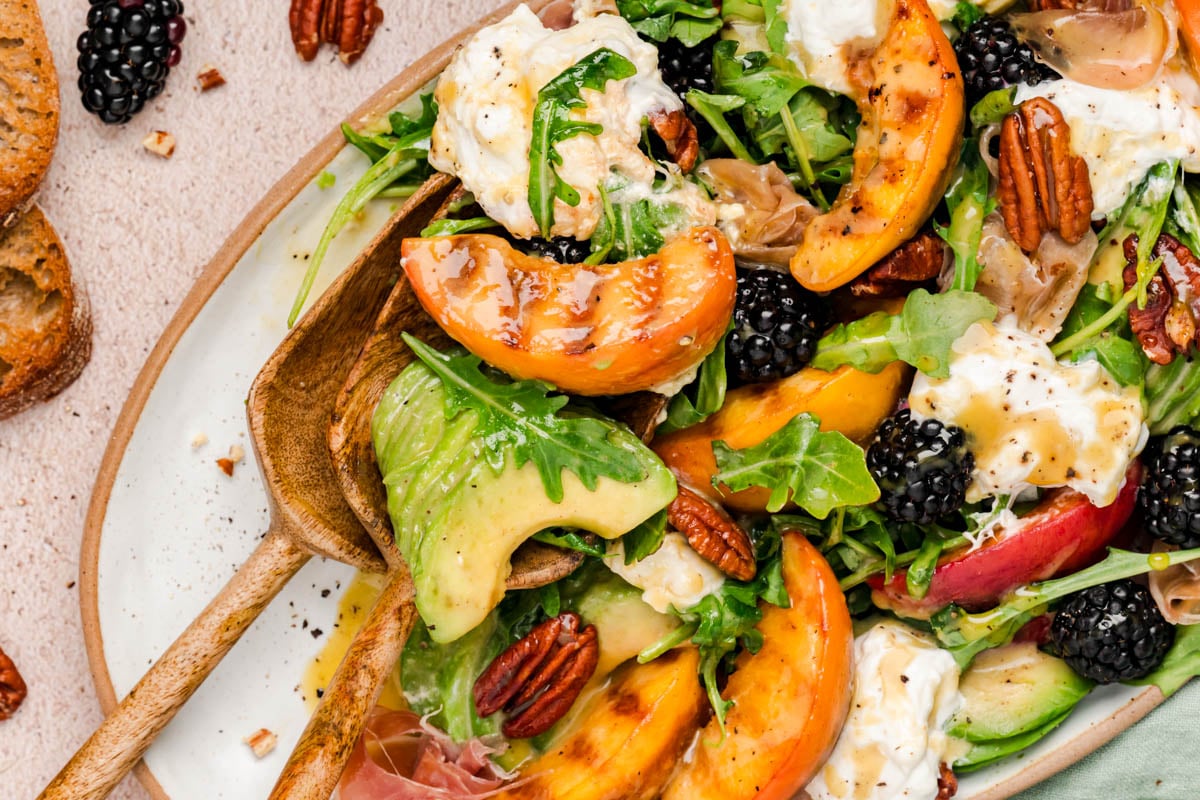 Peach Burrata salad on a table.