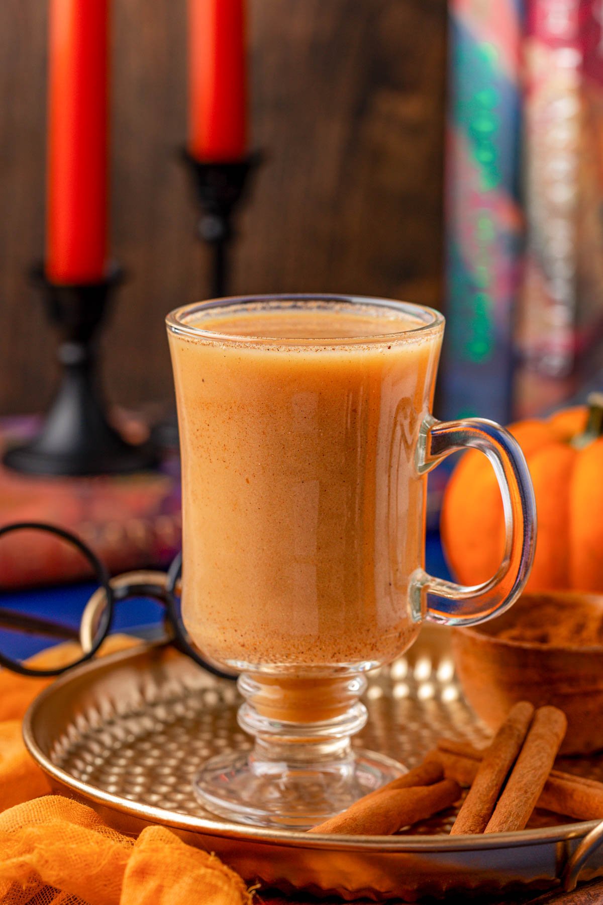 A goblet of pumpkin juice inspired by harry potter on a gold tray.