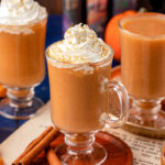 Three mugs of Harry Potter Pumpkin juice on a table.