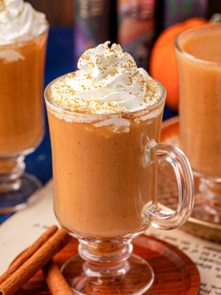 Three mugs of Harry Potter Pumpkin juice on a table.