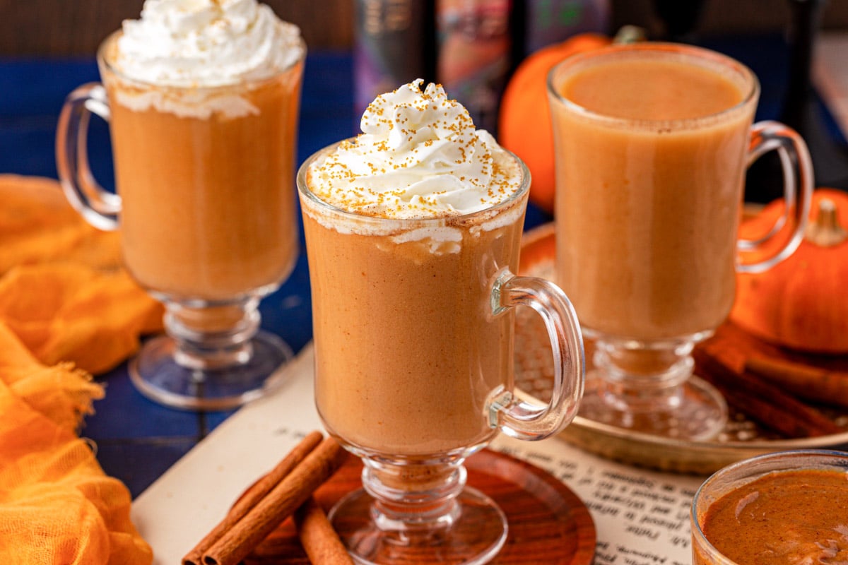 Three mugs of Harry Potter Pumpkin juice on a table.