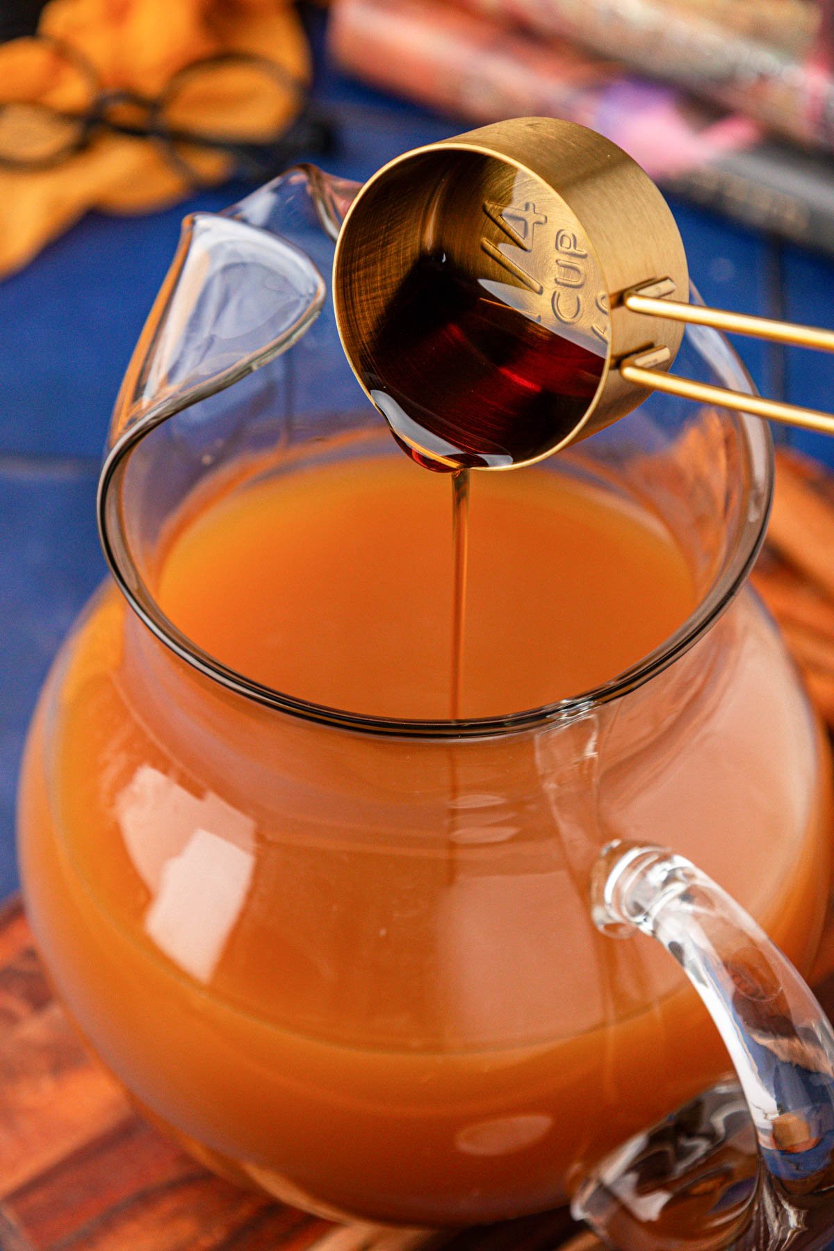 Maple syrup being poured into a pitcher to make pumpkin juice.