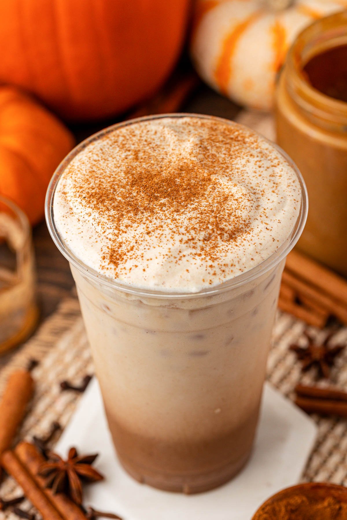 Close up of a tall cup of iced pumpkin spiced latte.