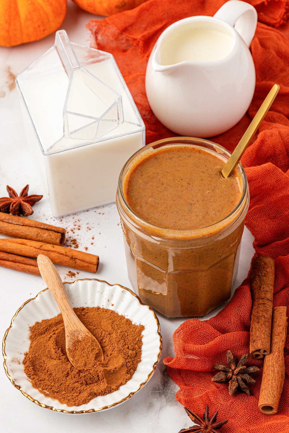 Ingredients to make pumpkin cold foam on a table.