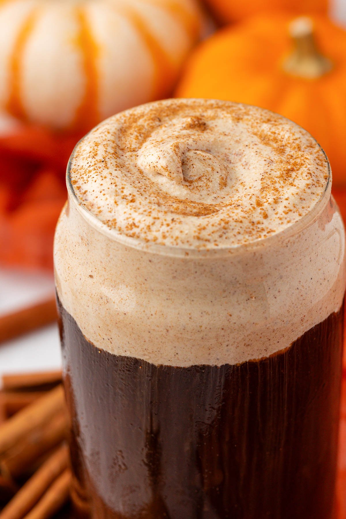 Close up of a glass of cold brew topped with pumpkin cold foam.