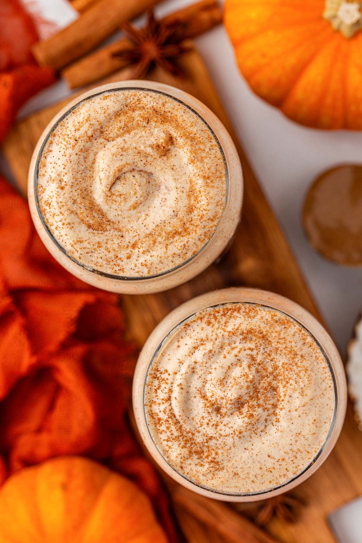 Overhead photo of two glasses of pumpkin cold foam.