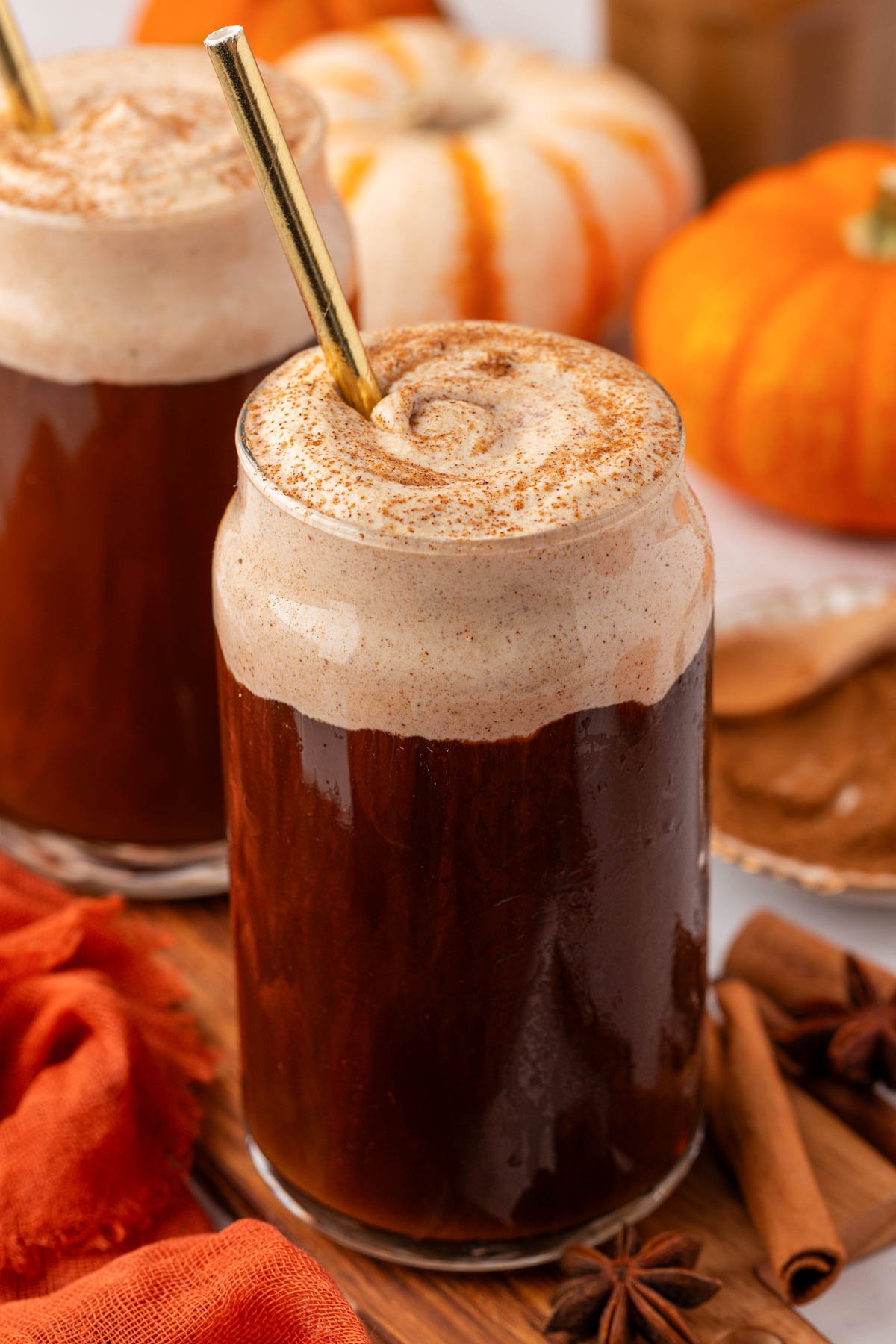 A glass filled with cold brew and topped with pumpkin cold foam.