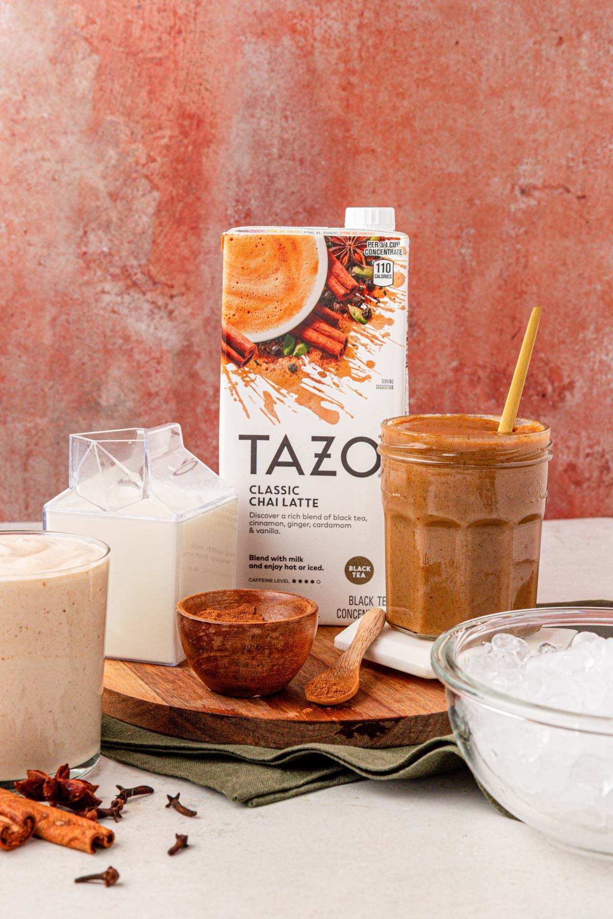 Ingredients to make a pumpkin chai latte on a table.