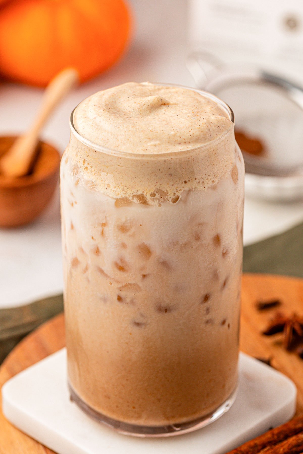 Homemade Pumpkin Cream Chai Latte on a white coaster.
