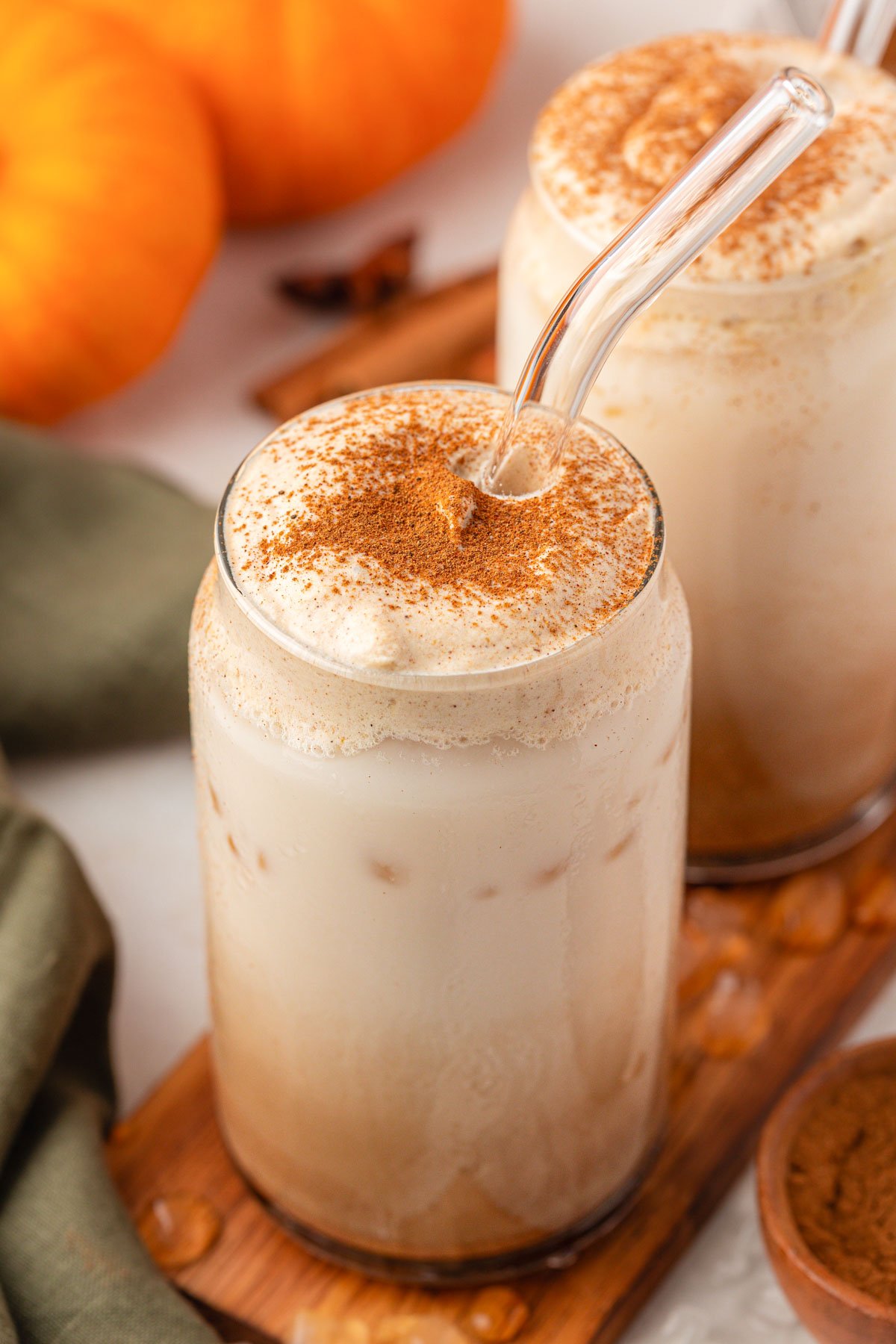 Close up of two glasses filled with pumpkin chai lattes.