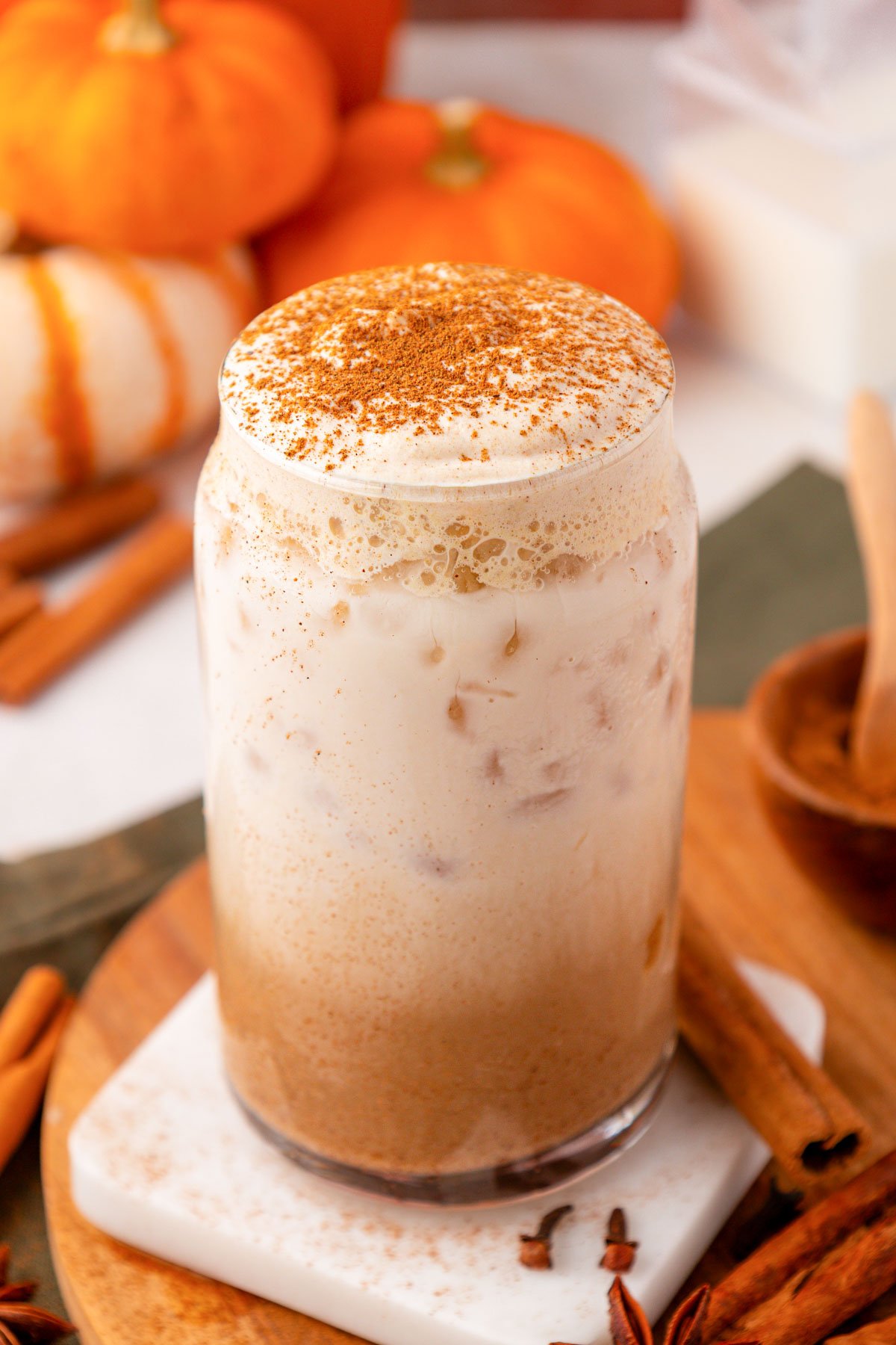 Close up of a Pumpkin Cream Chai Latte in a glass.