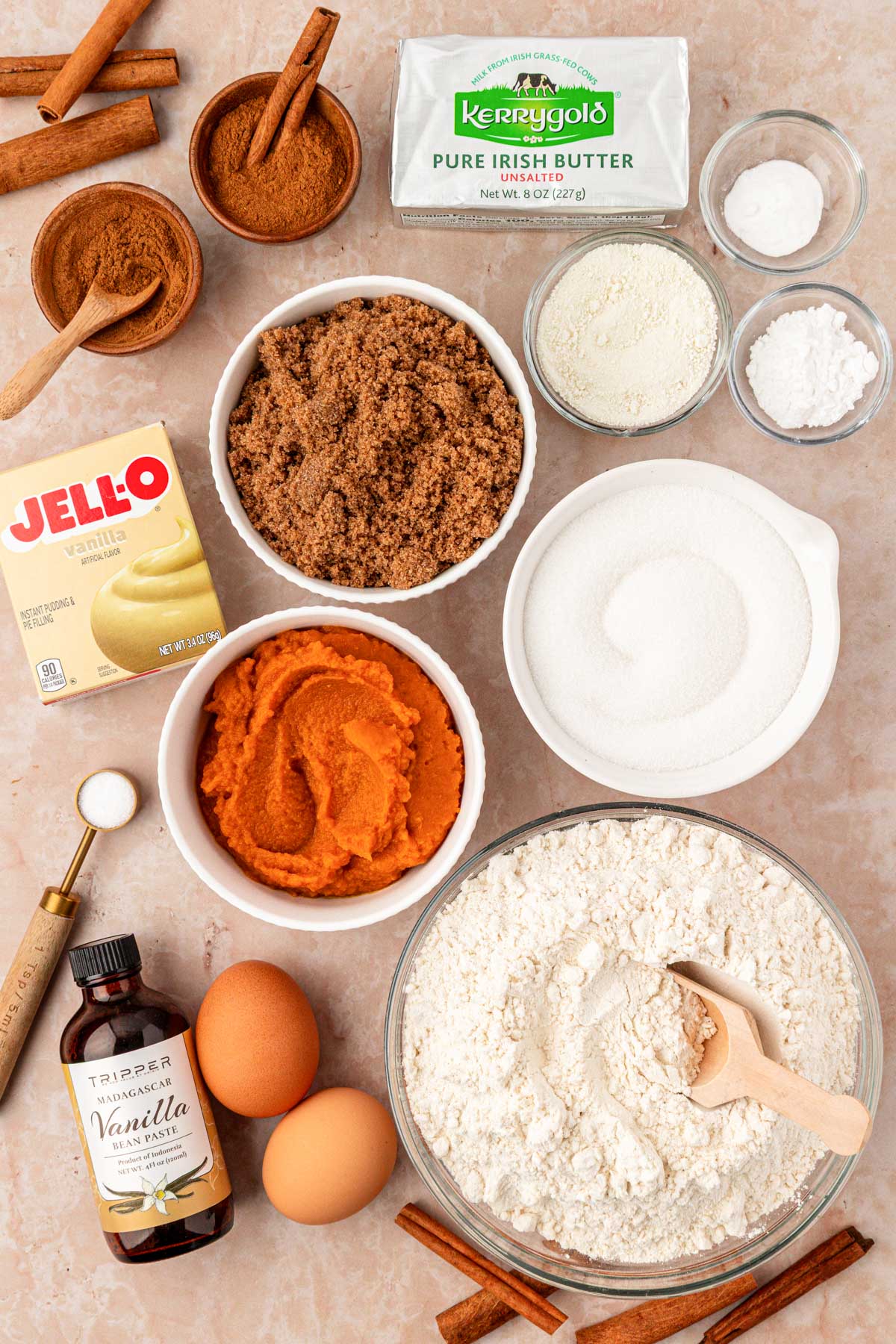 Ingredients to make pumpkin snickerdoodle cookies on a tan counter.