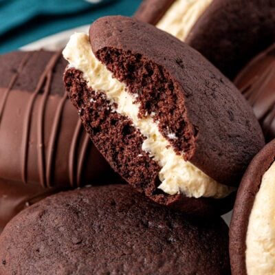 Whoopie pies on a a plate, one is missing a bite.