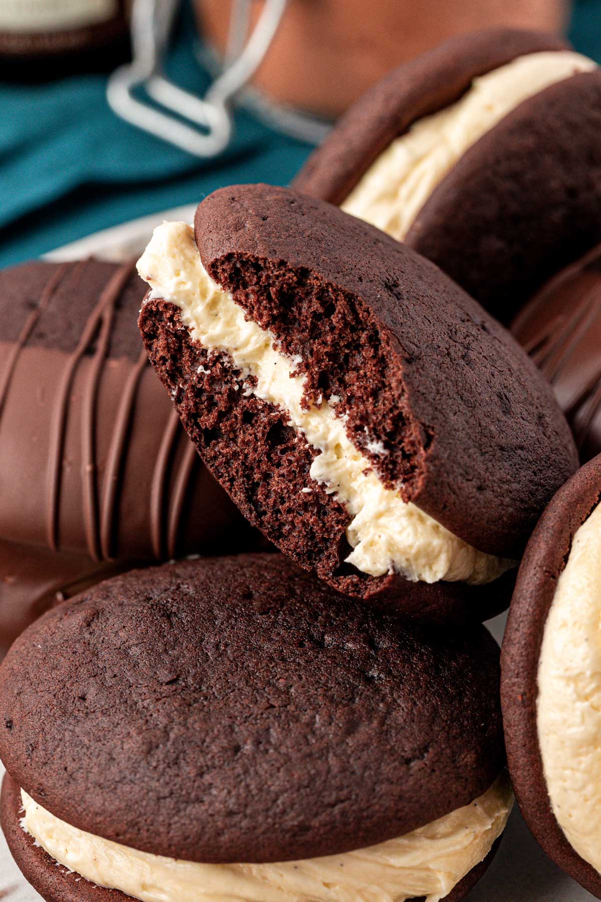 Whoopie pies on a a plate, one is missing a bite.