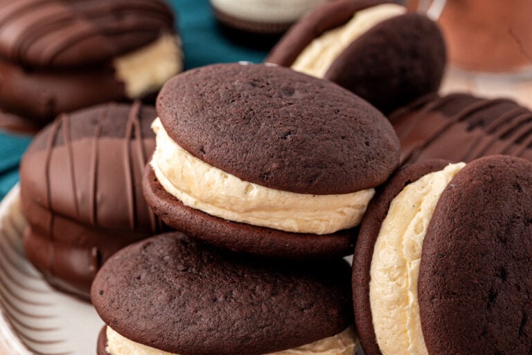 Whoopie pies on a a plate, one is missing a bite.