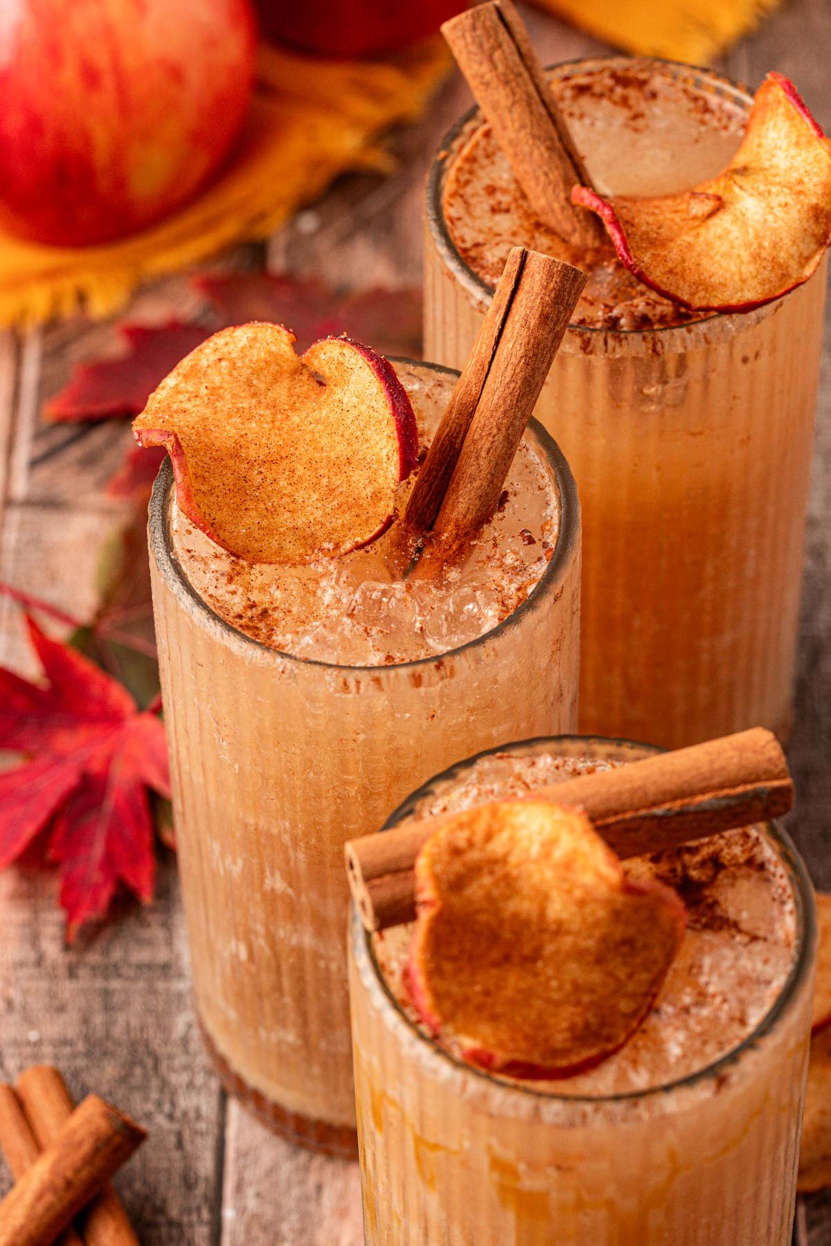 Three apple crisp refresher drinks on a table.