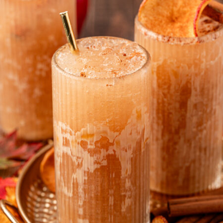 Close up of three glasses filled with apple crisp refreshers.