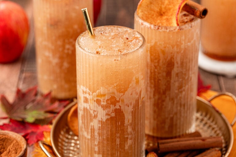 Close up of three glasses filled with apple crisp refreshers.