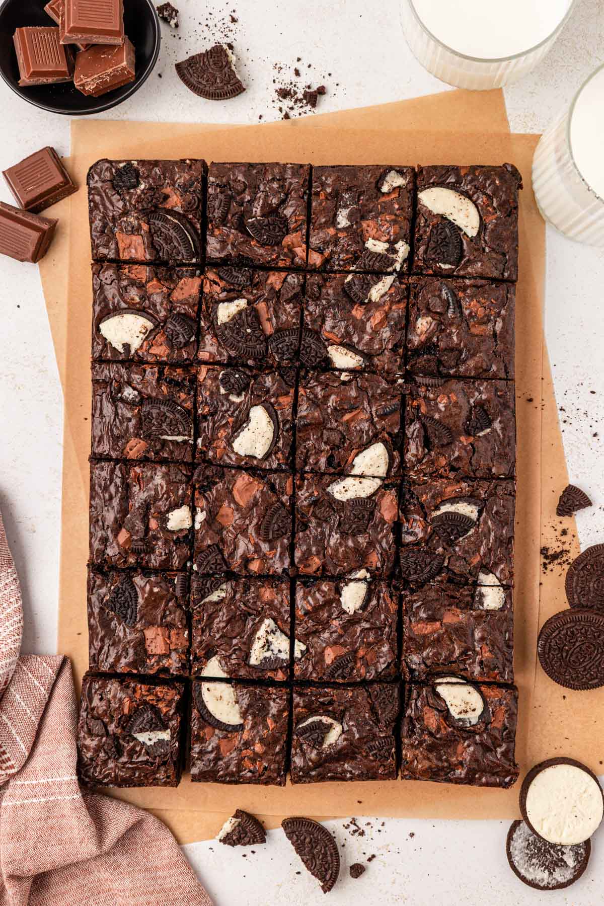 Overhead photo of a pan of brownie loaded with oreo pieces on a table.
