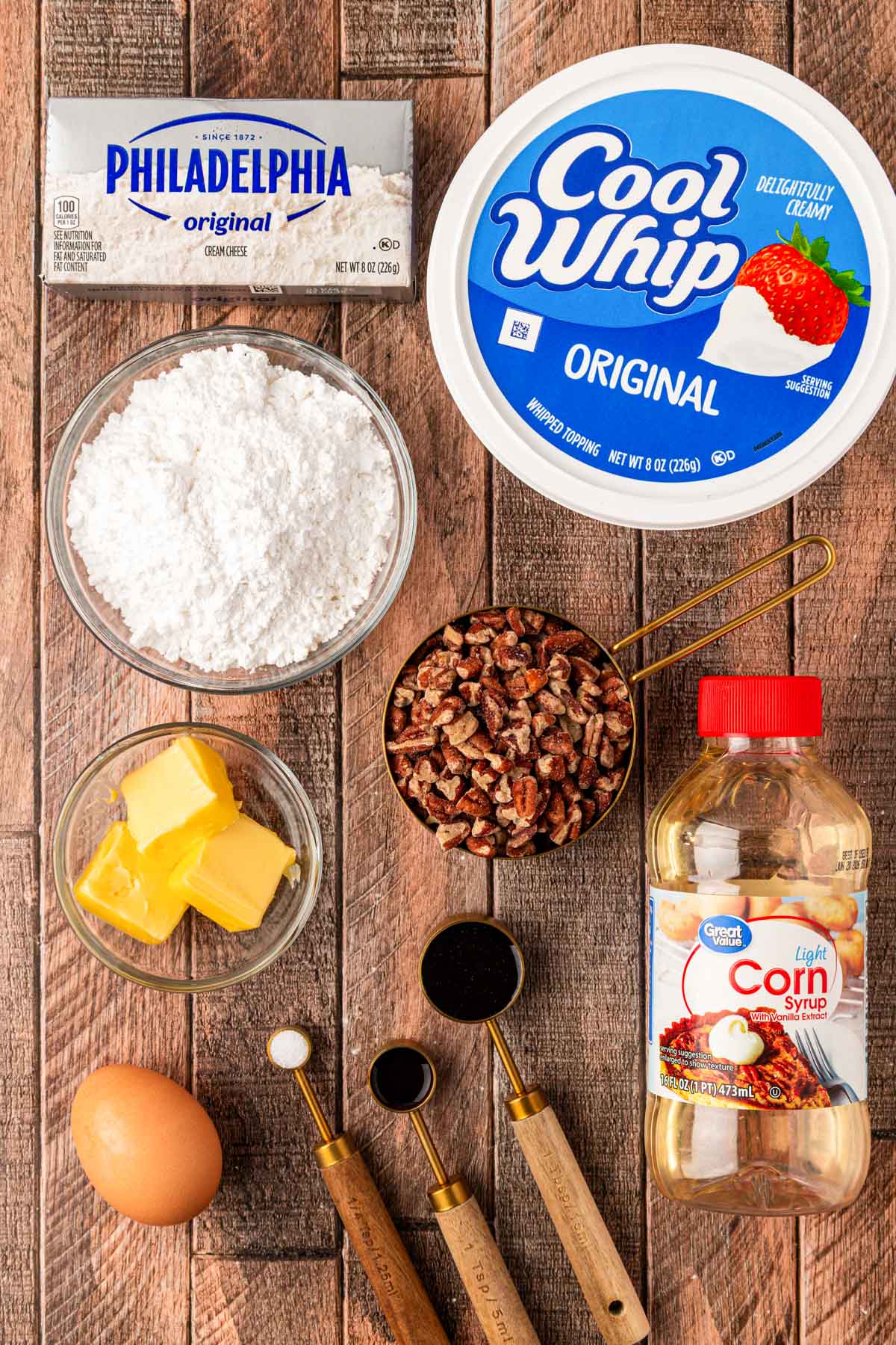Ingredients to make pecan pie dip on a wooden table.