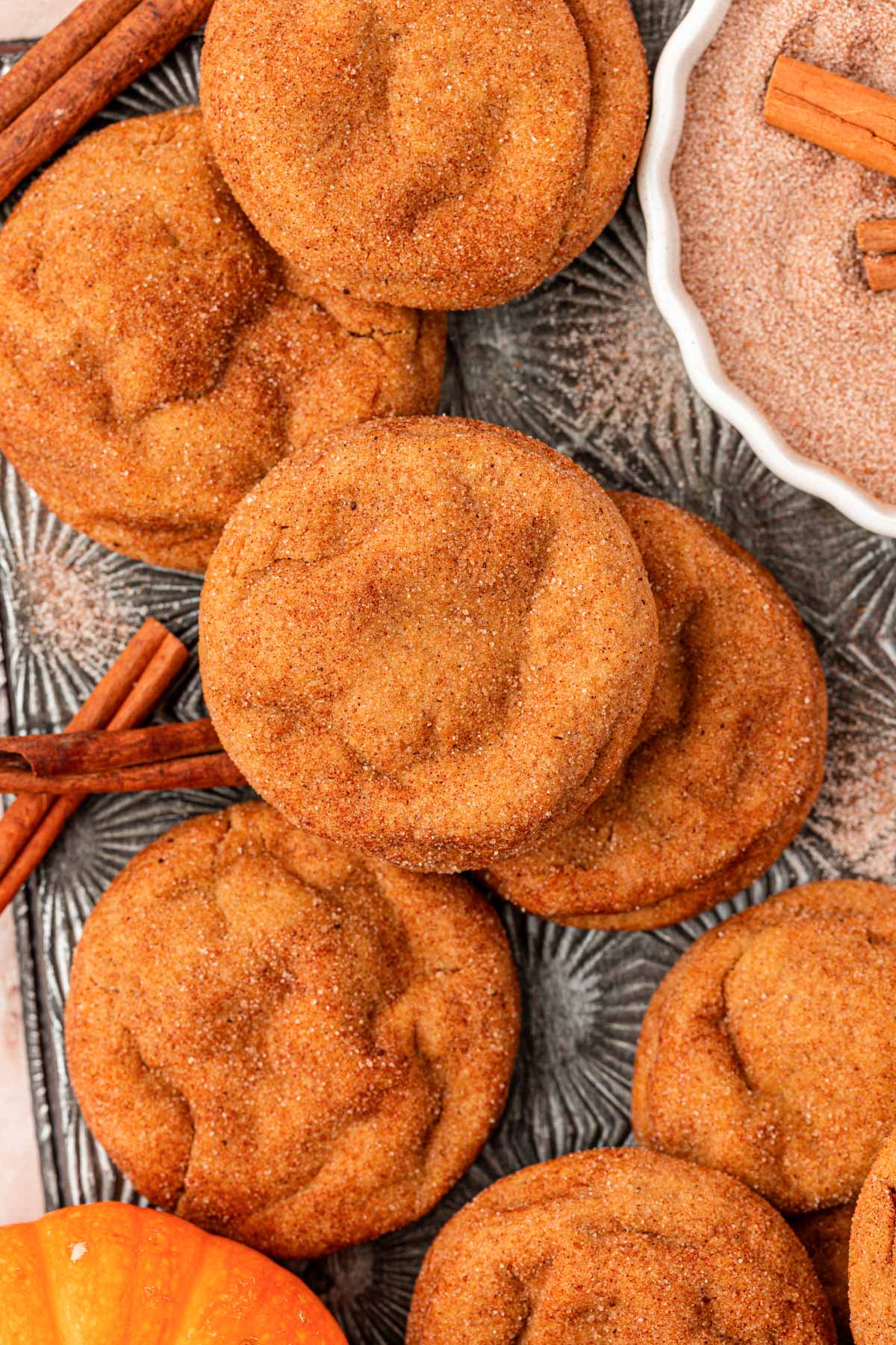 Overhead photo of pumpkin snickerdoodle cookies on a baking sheet.