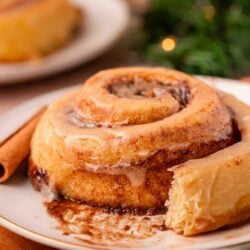 Eggnog cinnamon rolls on a white plate.